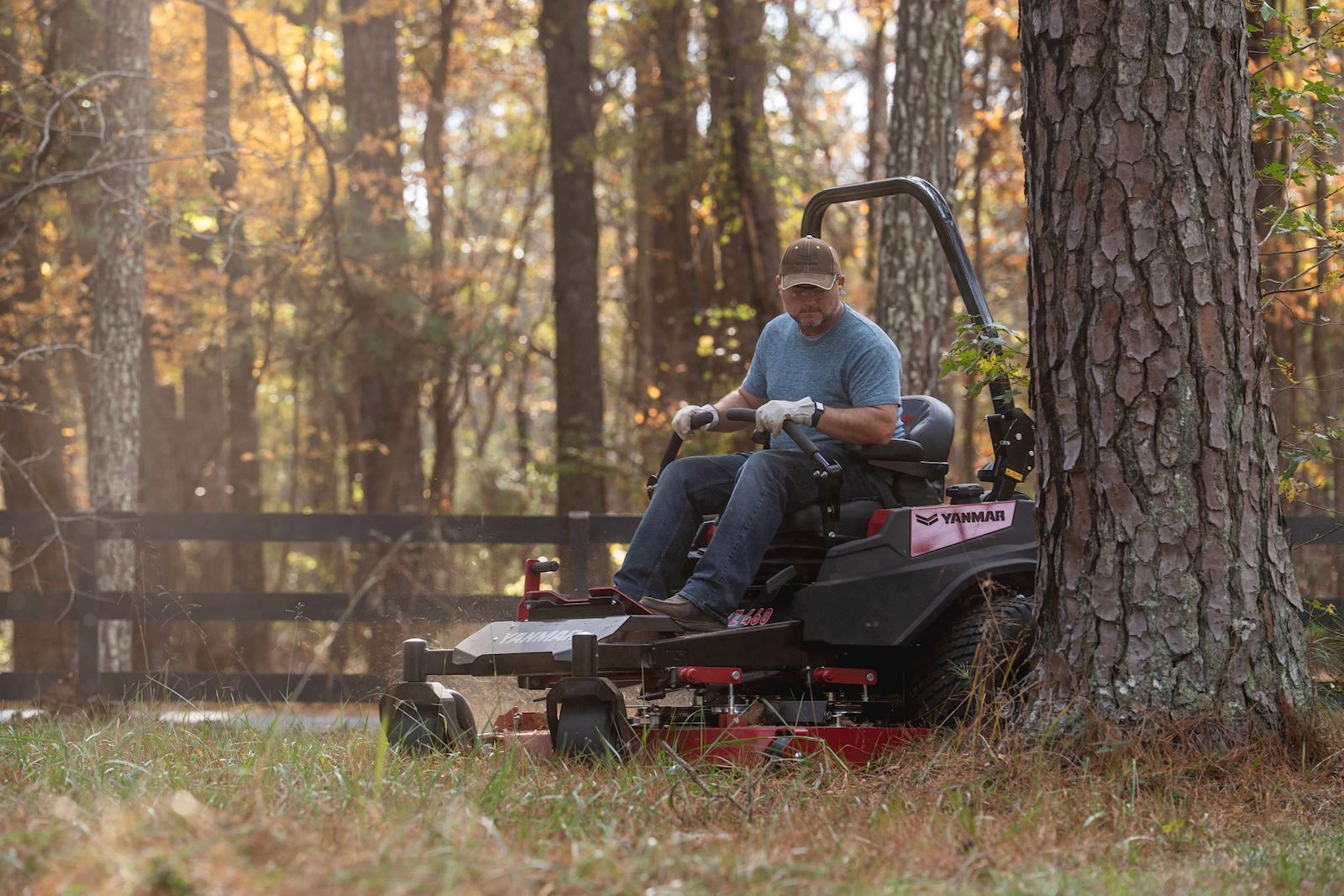 man mowing around a tree