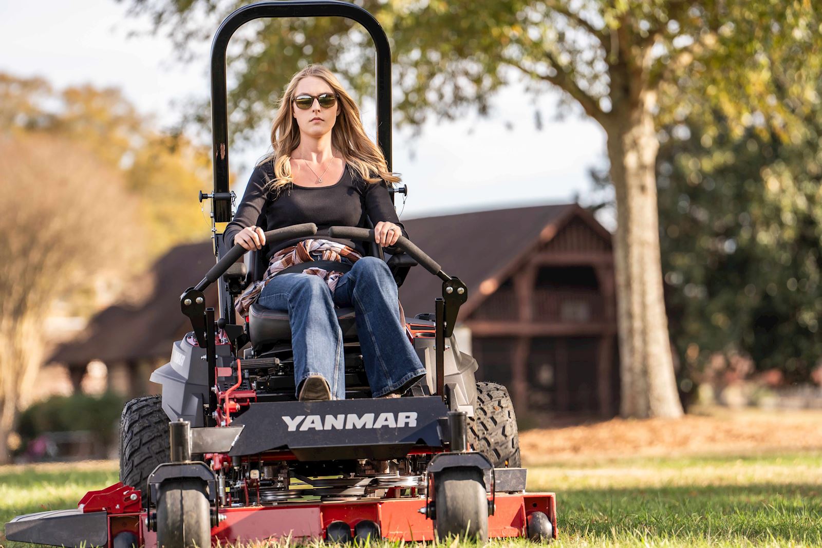 woman driving a Yanmar zero-turn mower